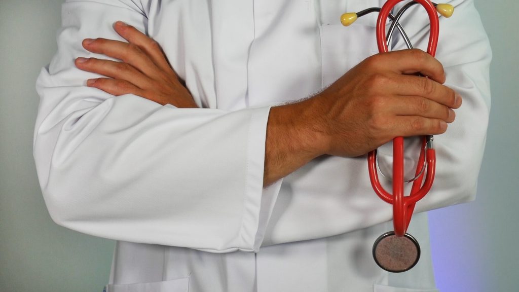 a doctor holding a baby's hand