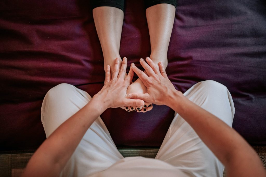 a close-up of several hands holding a ball