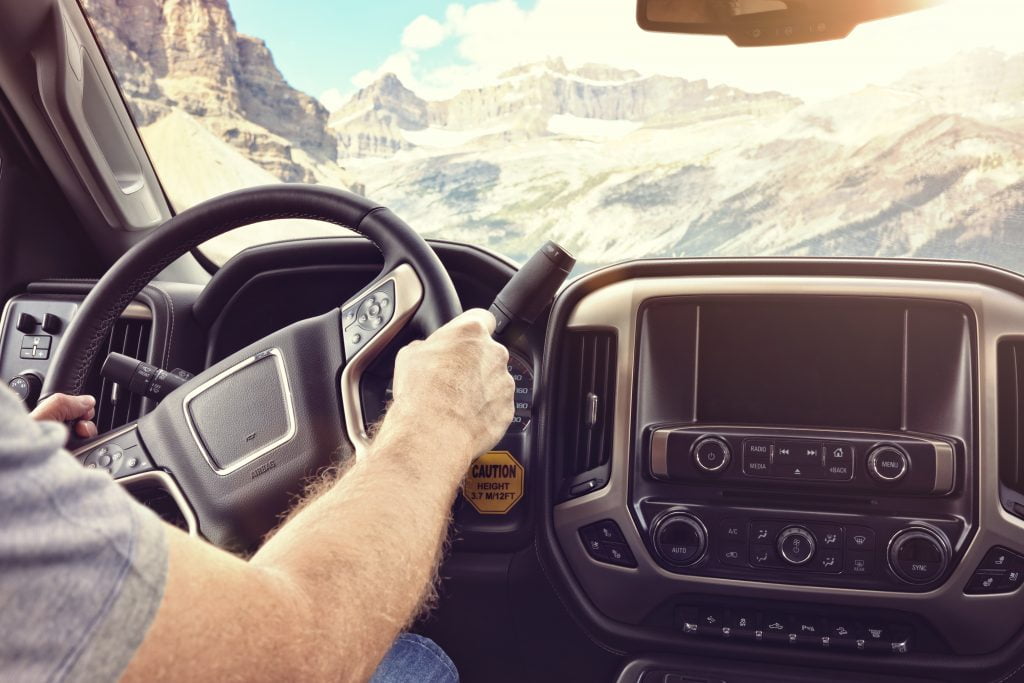 a person holding a phone in a car