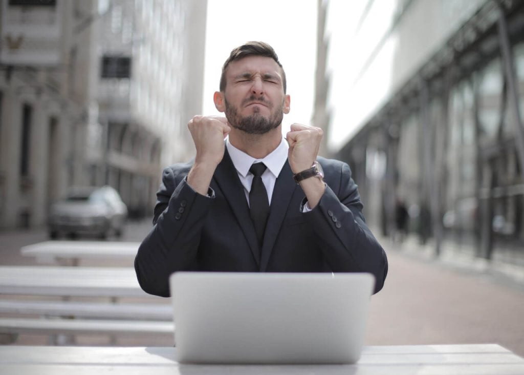 a man sitting in front of a laptop