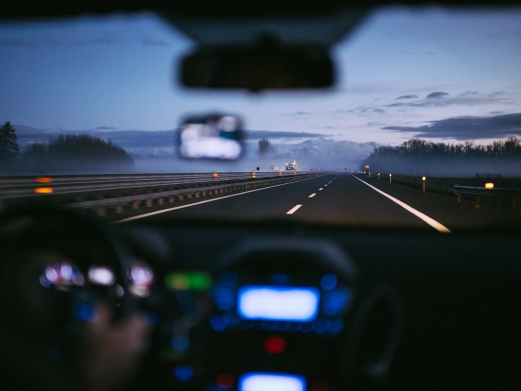 a view of a car's dashboard and the view of a snowy field
