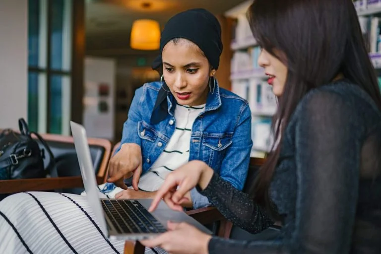 a person and a child using a laptop