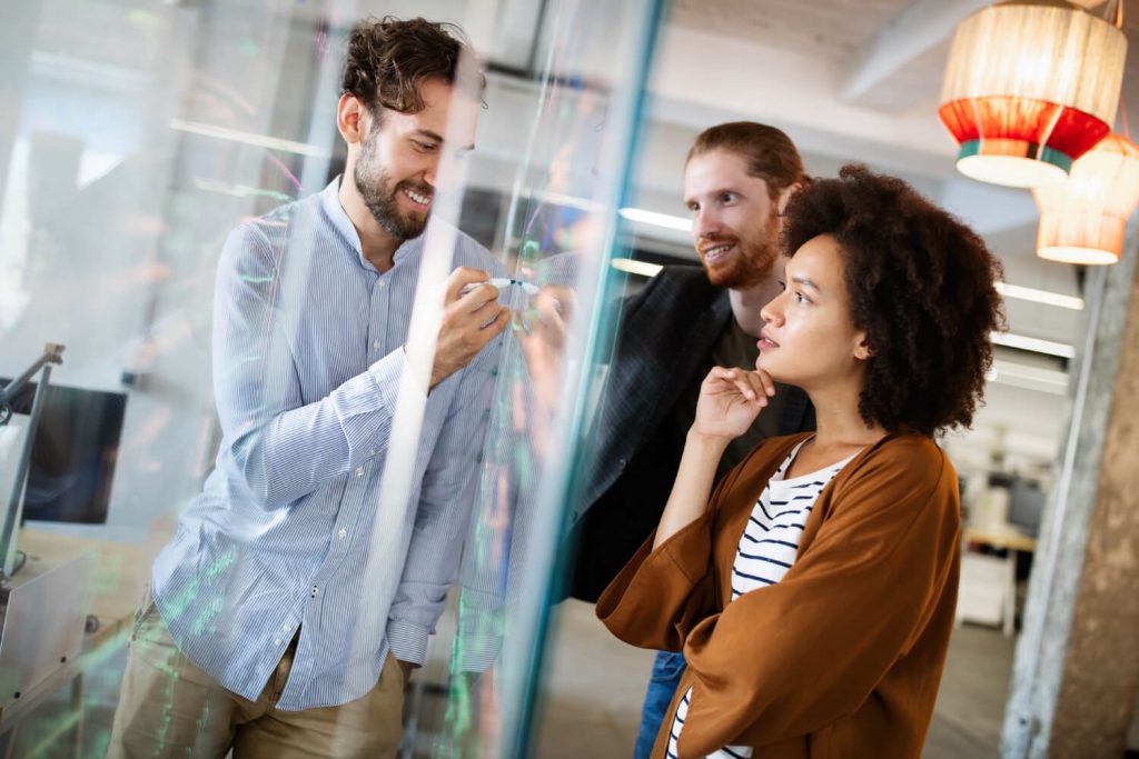 a man and a woman looking at a woman in a lab coat